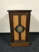 An antique pot cupboard with painted panel door