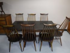 An Ercol refectory table and seven chairs