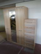 A contemporary pine effect wardrobe with matching six drawer chest