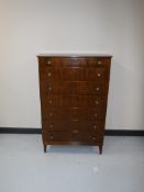 A mid 20th century walnut five drawer chest