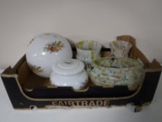 A box containing five glass lightshades