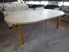 A circular heavy pine extending table,