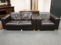 A brown leather two seater settee together with matching armchair