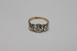 A superb 18ct gold and platinum three stone diamond ring,