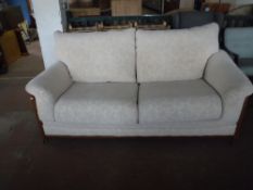 A contemporary beech framed three piece lounge suite upholstered in a beige fabric