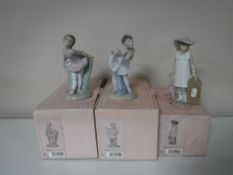 Three Nao figures, 'Girl Holding a Parasol',