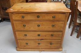 An antique pine four drawer chest