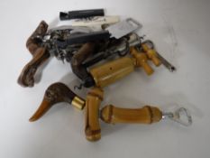 A box containing a collection of bottle openers and corkscrews.