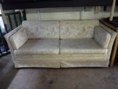 A twentieth century two seater settee upholstered in a beige fabric