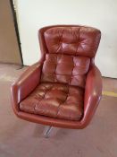 A mid twentieth century Dux red button leather swivel armchair on a chrome base