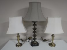 A pair of brass table lamps, with shades,
