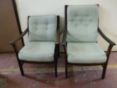 A pair of stained beech framed armchairs upholstered in green button fabric