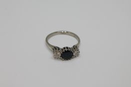 An 18ct gold three stone sapphire and diamond ring CONDITION REPORT: The ring is in