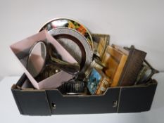 A box containing plated ware, dressing table sets, carriage clock,