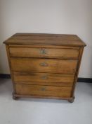 An antique pine four drawer chest
