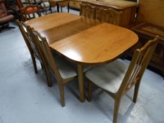A teak extending dining table and four chairs