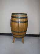 An oak metal bound barrel cabinet