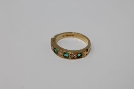 An 18ct gold emerald and diamond half-eternity ring,