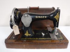 A mid twentieth century oak cased Singer hand sewing machine