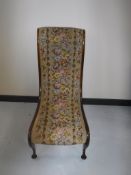 A late 19th century mahogany nursing chair