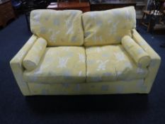 A contemporary three seater and two seater settee in a yellow Oriental print
