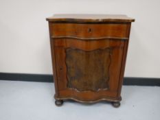 A mahogany cabinet fitted a drawer on bun feet