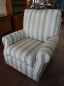 A contemporary armchair upholstered in a green striped fabric
