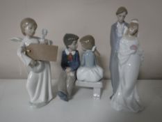 Three Nao figures; boy and girl on bench, angel,