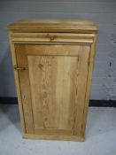An antique pine cupboard fitted a drawer