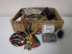 A basket containing a quantity of assorted costume jewellery, including necklaces, earrings,