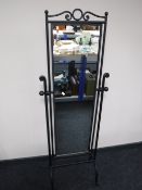A wrought iron cheval mirror