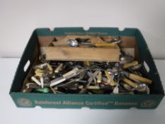 A box of miscellaneous cutlery