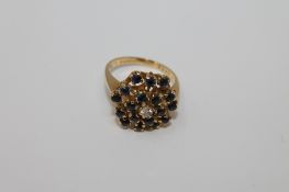 An 18ct gold sapphire and diamond cluster ring, 7.