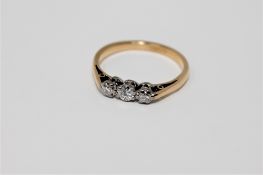 An 18ct gold three stone diamond ring