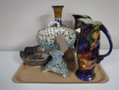 A tray containing a pair of Maling Storm jugs, together with a Ringtons Maling lustre jug,