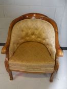 A 20th century mahogany framed scroll arm armchair