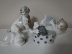 Four Nao figures of animals, including puppies in a basket,
