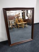 A framed bevel edge overmantel mirror