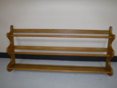 An oak wall mounted plate rack