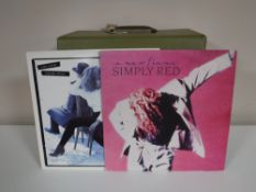 A case containing LP's, compilations, John Lennon, Wings,