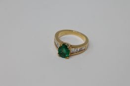 An 18ct gold emerald and diamond ring,