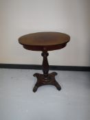 An antique mahogany pedestal table