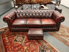 A burgundy leather chesterfield three seater settee, width 220cm,