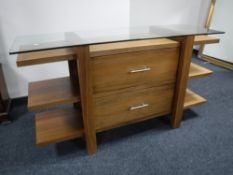 A glass topped console table in a walnut finish