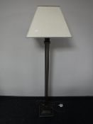 A contemporary floor lamp with shade