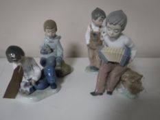 Four Nao figures including boy with train,