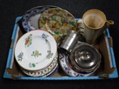 A box containing assorted dinner plates and wall plates,