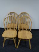 Four contemporary dining chairs in a pine finish