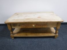 A heavy pine two tier coffee table fitted a drawer