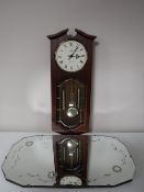 A decorative frameless bevel edge mirror together with a contemporary Abbey wall clock